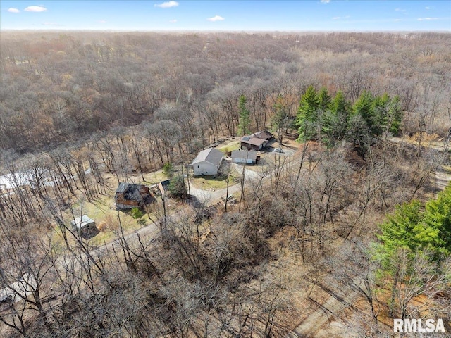drone / aerial view featuring a wooded view