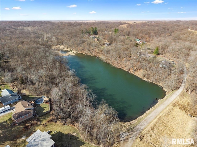 drone / aerial view featuring a water view and a view of trees