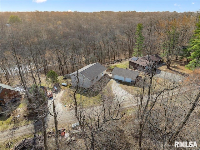 birds eye view of property with a view of trees