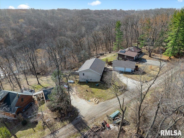 birds eye view of property featuring a view of trees