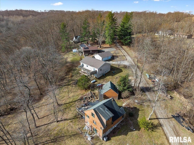 birds eye view of property with a wooded view