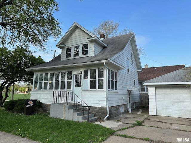 bungalow-style house with a chimney, a front yard, a shingled roof, and a garage