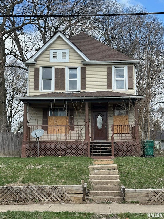 707 E Ravine Ave, Peoria, IL 61603 - view of front of home featuring a front lawn, a shingled roof, covered porch, and fence