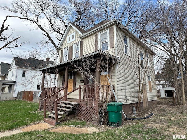 707 E Ravine Ave, Peoria, IL 61603 - view of front of property featuring a porch, a front lawn, an outbuilding, a storage unit, and fence