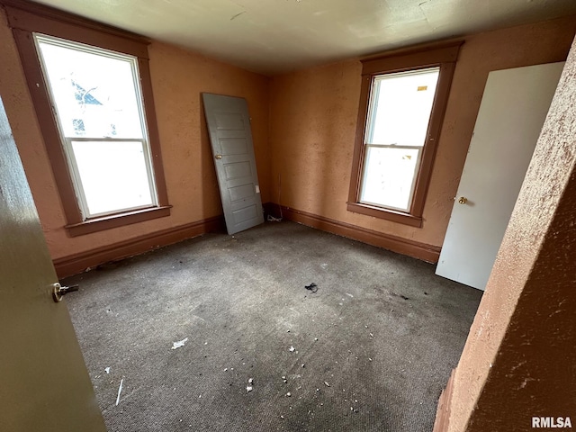 707 E Ravine Ave, Peoria, IL 61603 - unfurnished bedroom with carpet flooring and multiple windows