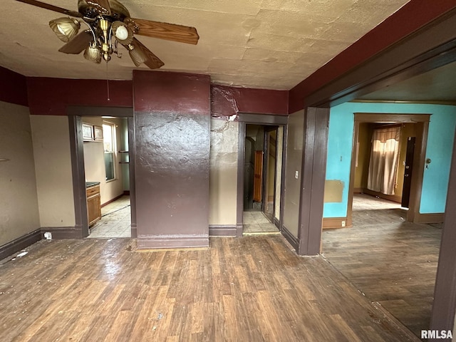 707 E Ravine Ave, Peoria, IL 61603 - spare room with a ceiling fan, wood finished floors, and baseboards