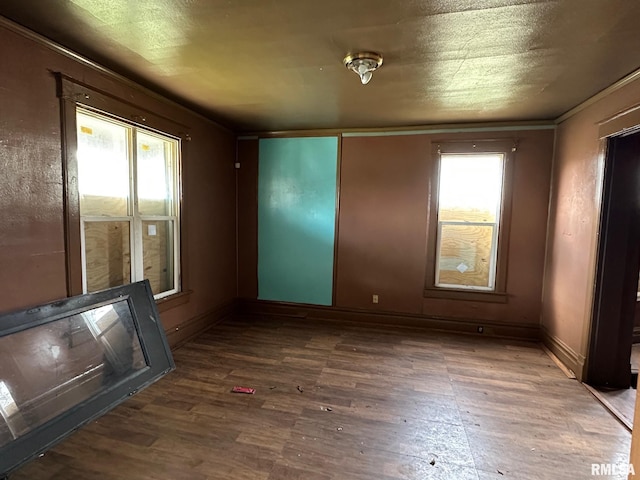 707 E Ravine Ave, Peoria, IL 61603 - unfurnished room featuring baseboards, wood finished floors, and plenty of natural light