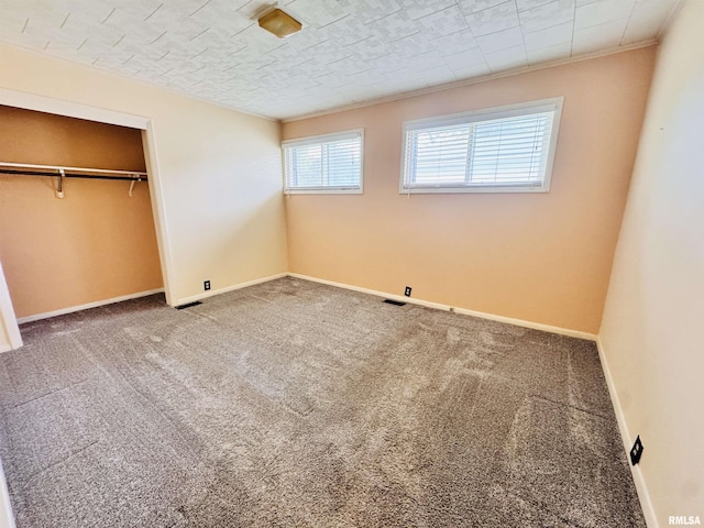 711 E Piper St, Macomb, IL 61455 - unfurnished bedroom featuring carpet, a closet, baseboards, and crown molding