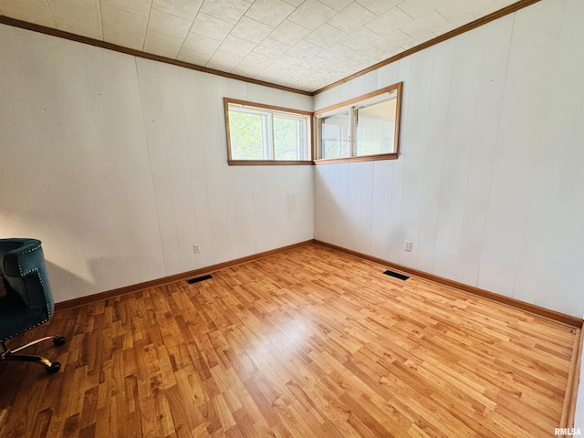 711 E Piper St, Macomb, IL 61455 - unfurnished room with crown molding, light wood-style floors, and baseboards