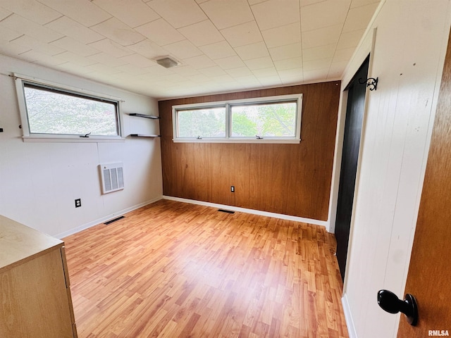 711 E Piper St, Macomb, IL 61455 - empty room featuring light wood-style floors and wooden walls