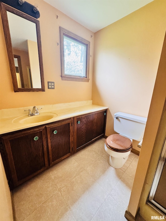 711 E Piper St, Macomb, IL 61455 - bathroom featuring toilet, vanity, and tile patterned flooring