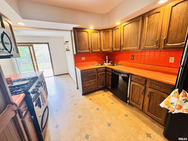 711 E Piper St, Macomb, IL 61455 - kitchen featuring dishwasher, a sink, range with gas stovetop, light countertops, and recessed lighting