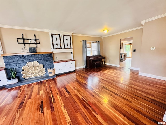 711 E Piper St, Macomb, IL 61455 - unfurnished living room with wood finished floors, ornamental molding, and baseboards