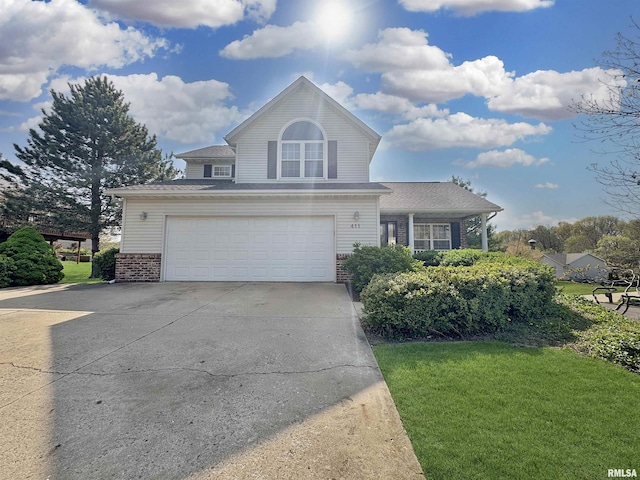 view of front facade with a garage, concrete driveway, a front yard, and brick siding