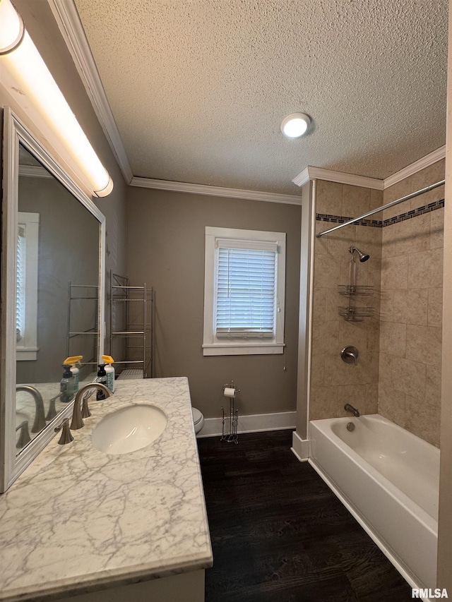 full bathroom with vanity, ornamental molding, a textured ceiling, and wood finished floors