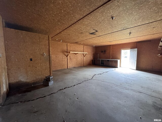 miscellaneous room with a garage and concrete floors