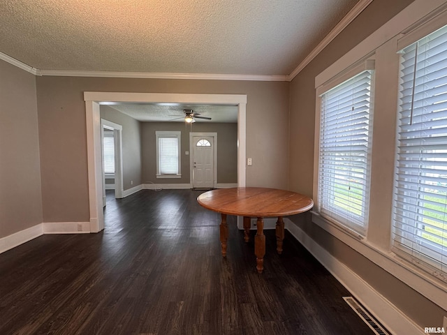 entrance foyer with visible vents, a textured ceiling, baseboards, and dark wood finished floors