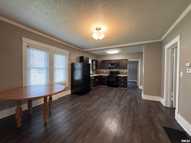 kitchen featuring visible vents, dark wood-type flooring, light countertops, a textured ceiling, and black appliances