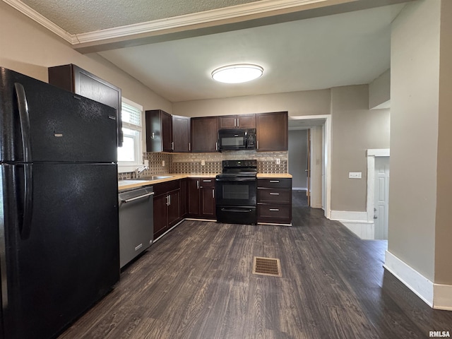 kitchen with visible vents, dark wood-style flooring, light countertops, a sink, and black appliances