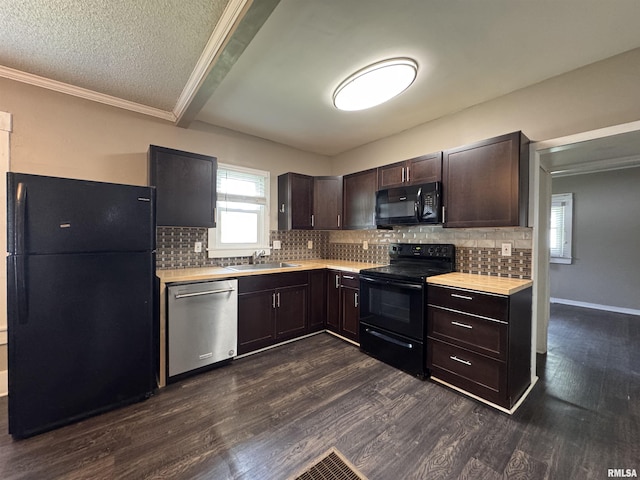 kitchen featuring dark brown cabinetry, a sink, light countertops, black appliances, and dark wood-type flooring