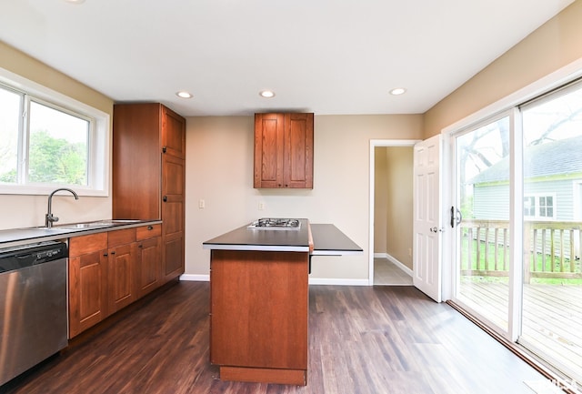 kitchen featuring recessed lighting, dark wood finished floors, a sink, brown cabinets, and stainless steel appliances