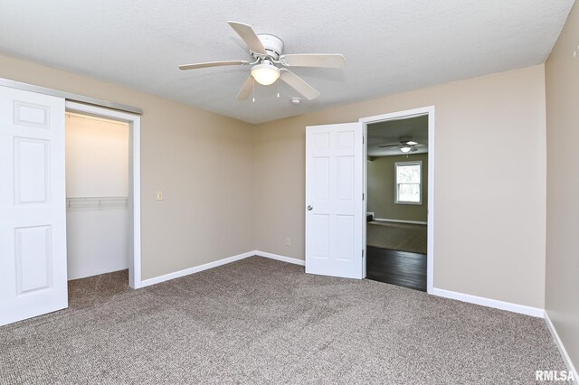 unfurnished bedroom with carpet flooring, baseboards, and a closet
