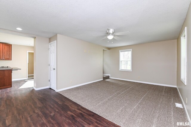 spare room featuring ceiling fan, recessed lighting, baseboards, and dark wood finished floors