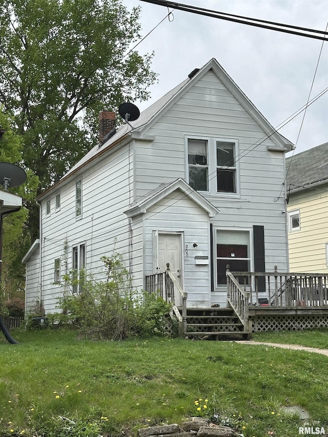 200 E Thrush Ave, Peoria, IL 61603 - view of front of home featuring a front lawn, a chimney, and a deck