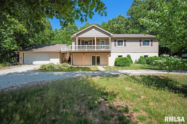 25633 N County Road 2500 E, Manito, IL 61546 - view of front facade featuring stairs, gravel driveway, a wooden deck, and an attached garage