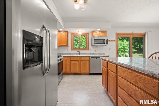 25633 N County Road 2500 E, Manito, IL 61546 - kitchen with appliances with stainless steel finishes, a sink, plenty of natural light, light stone counters, and a textured ceiling
