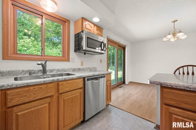 25633 N County Road 2500 E, Manito, IL 61546 - kitchen featuring stainless steel appliances, a sink, a chandelier, light tile patterned flooring, and a textured ceiling