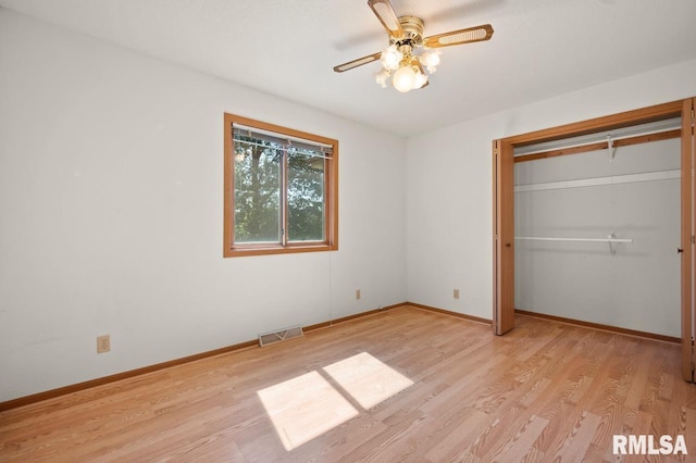 25633 N County Road 2500 E, Manito, IL 61546 - unfurnished bedroom with light wood-style flooring, baseboards, a closet, and a ceiling fan