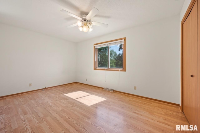 25633 N County Road 2500 E, Manito, IL 61546 - unfurnished bedroom featuring light wood-style floors, a closet, baseboards, and ceiling fan