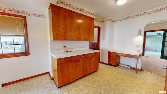 kitchen with light countertops, visible vents, brown cabinetry, and light floors