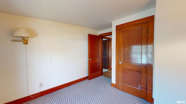 carpeted bedroom featuring baseboards