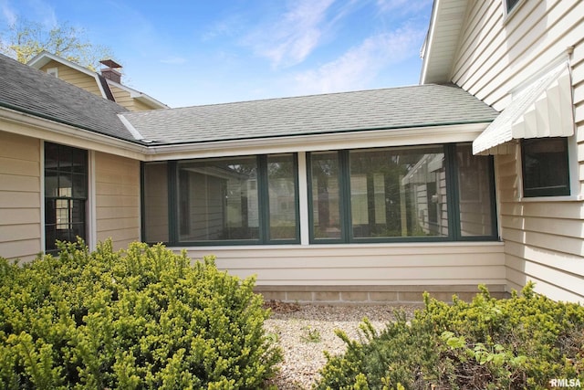 view of property exterior featuring a shingled roof