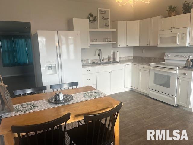 kitchen featuring open shelves, a sink, light countertops, white appliances, and white cabinetry