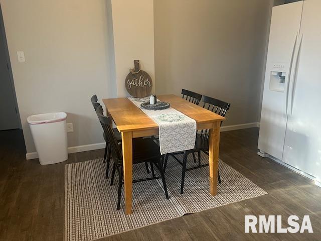 dining area with baseboards and wood finished floors