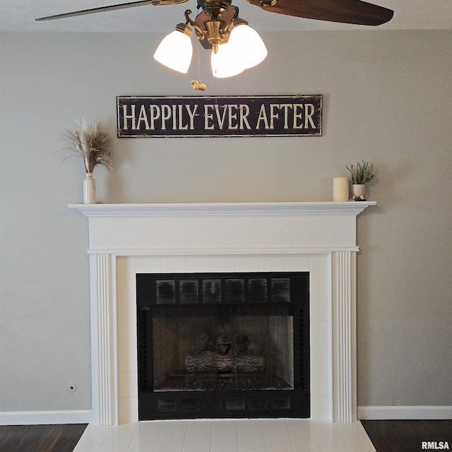 details with a ceiling fan, baseboards, and a tiled fireplace