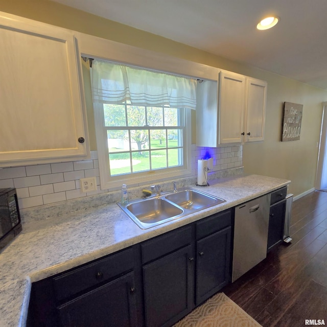 kitchen with a sink, white cabinets, dark wood finished floors, and dishwasher