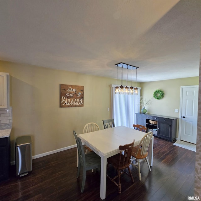 dining space featuring baseboards and dark wood-style flooring