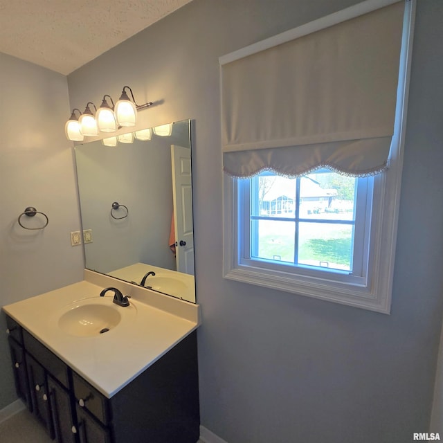bathroom featuring baseboards and vanity