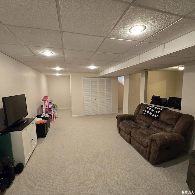 carpeted living room featuring a drop ceiling and recessed lighting