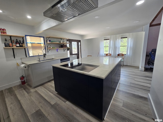 kitchen featuring a sink, premium range hood, open shelves, and black electric stovetop