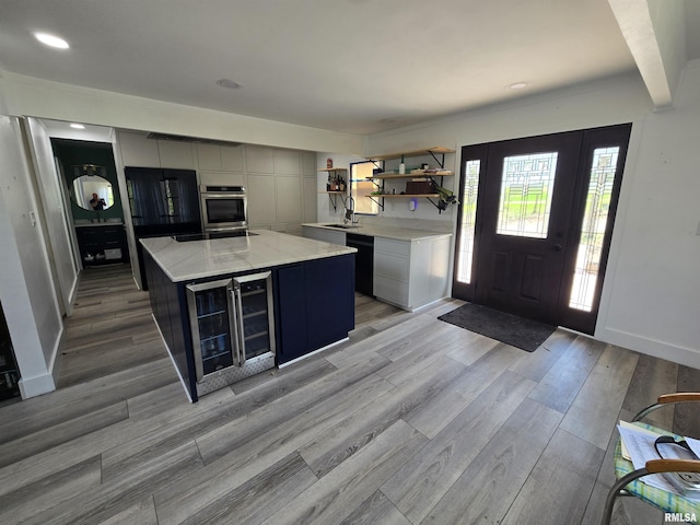 interior space featuring recessed lighting, baseboards, light wood finished floors, and wine cooler