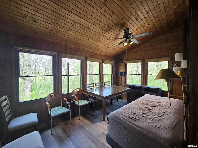bedroom featuring wooden walls, wood ceiling, vaulted ceiling, and hardwood / wood-style flooring