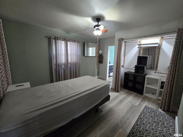bedroom with a ceiling fan and hardwood / wood-style flooring