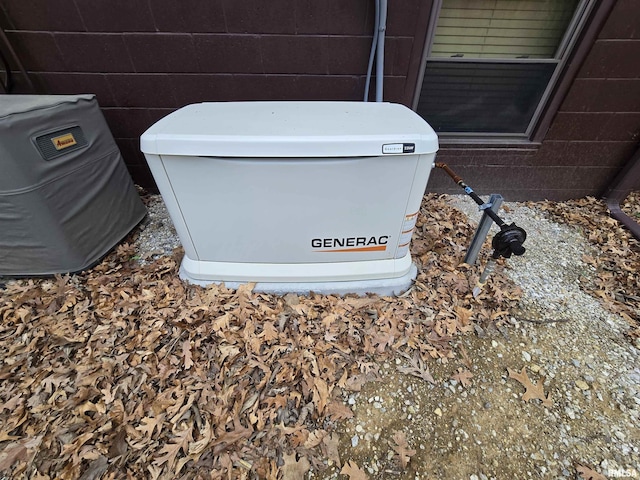 details featuring a power unit and concrete block siding