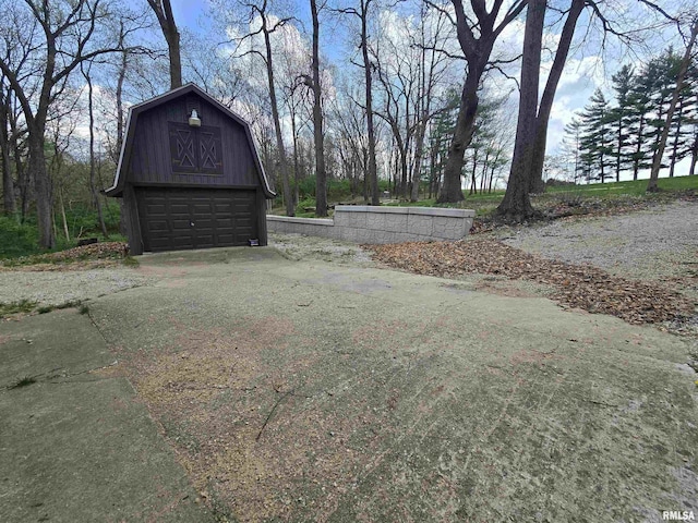 view of yard with a barn, an outbuilding, and a detached garage