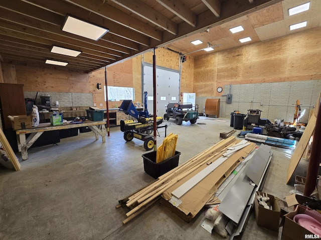 misc room with a workshop area and concrete flooring